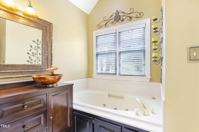 117 Vicksburg Dr, Cary, NC 27513 - full bathroom featuring lofted ceiling, a whirlpool tub, and vanity