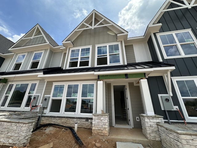 3020 White Rail Dr, Fuquay Varina, NC 27526 - view of front facade featuring a standing seam roof, a metal roof, board and batten siding, and stone siding