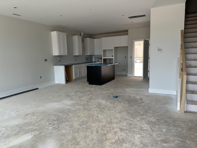 3020 White Rail Dr, Fuquay Varina, NC 27526 - kitchen with a kitchen island, white cabinetry, and open floor plan