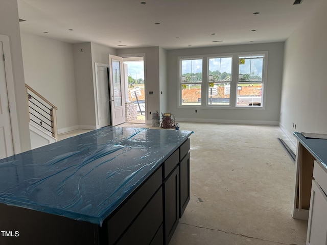 3020 White Rail Dr, Fuquay Varina, NC 27526 - kitchen featuring open floor plan, concrete floors, dark stone counters, and dark cabinets