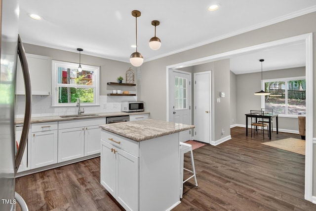 1500 Valley, Durham, NC 27707 - kitchen with healthy amount of natural light, decorative backsplash, white cabinetry, stainless steel appliances, and ornamental molding