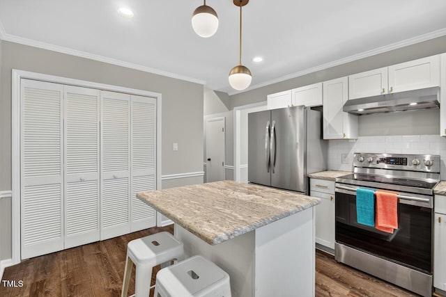 1500 Valley, Durham, NC 27707 - kitchen featuring stainless steel appliances, under cabinet range hood, white cabinetry, ornamental molding, and dark wood finished floors