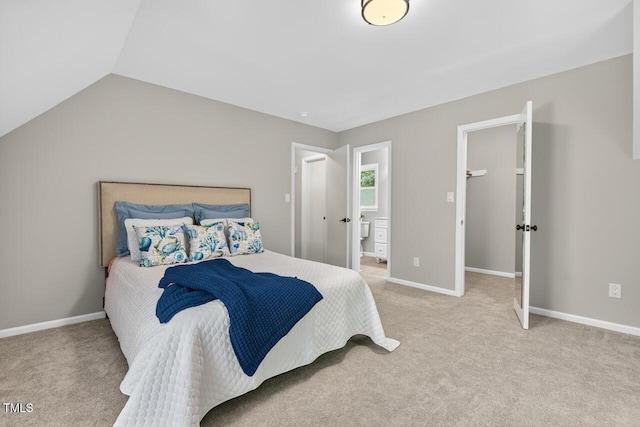 1500 Valley, Durham, NC 27707 - bedroom with light colored carpet, vaulted ceiling, and connected bathroom
