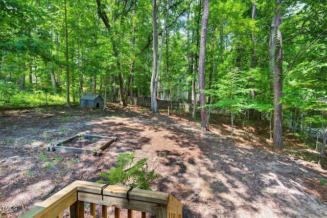1500 Valley, Durham, NC 27707 - fenced backyard featuring a storage unit and a garden