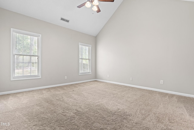 empty room with a healthy amount of sunlight, a ceiling fan, visible vents, and carpet
