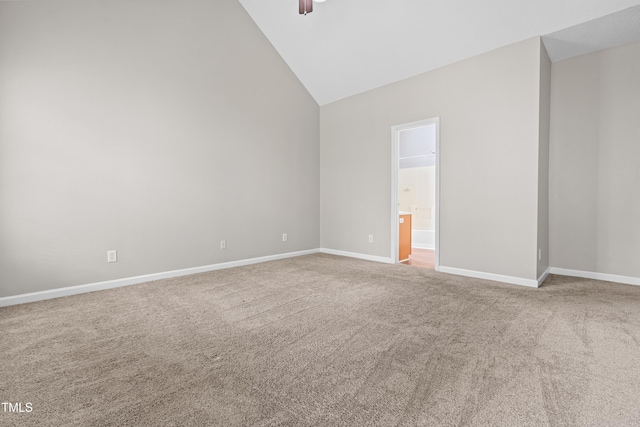 carpeted empty room featuring high vaulted ceiling, baseboards, and ceiling fan