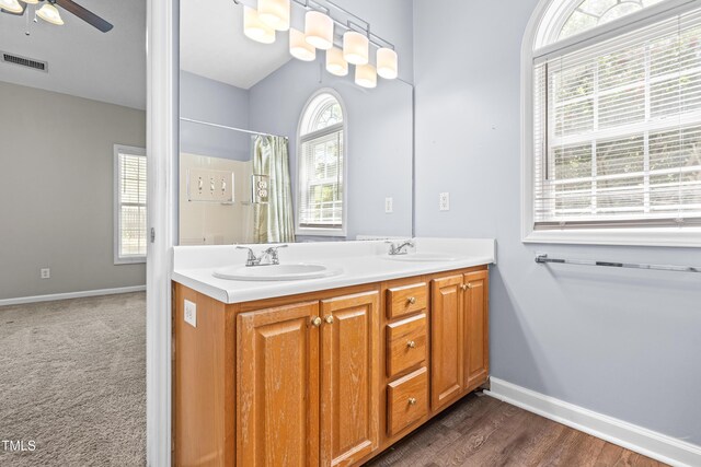 full bath featuring baseboards, ceiling fan, a sink, and visible vents