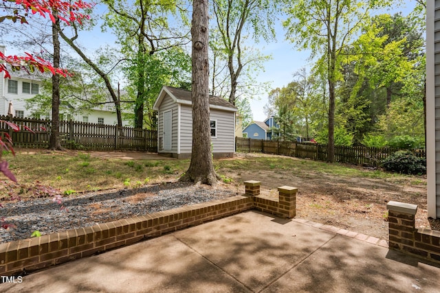 view of patio featuring a fenced backyard and an outbuilding