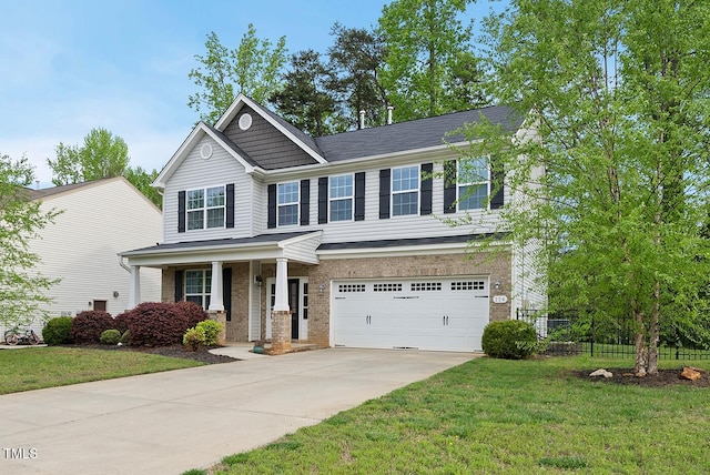 craftsman house featuring concrete driveway, a front lawn, an attached garage, brick siding, and fence