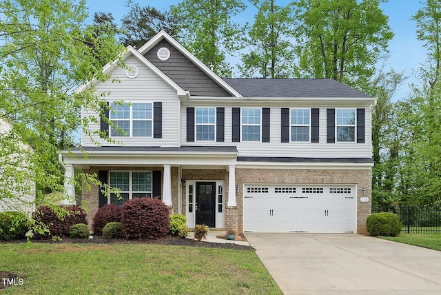 craftsman-style home with a garage, fence, driveway, and a front lawn