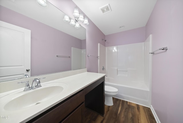 full bath featuring visible vents, toilet, shower / bathing tub combination, vanity, and wood finished floors