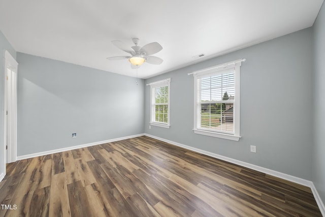 empty room featuring visible vents, baseboards, a ceiling fan, and wood finished floors