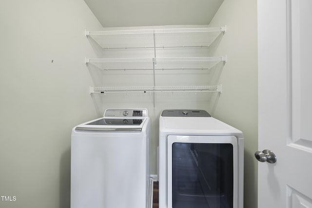 laundry room featuring separate washer and dryer and laundry area