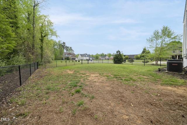 view of yard with fence and central air condition unit