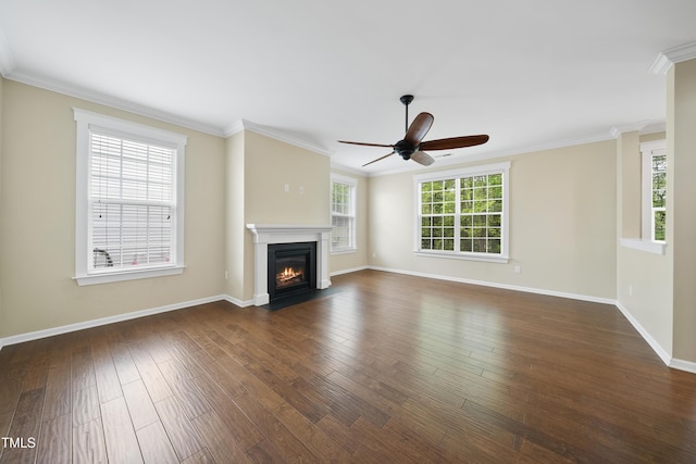 unfurnished living room with crown molding, ceiling fan, dark wood finished floors, a fireplace with flush hearth, and baseboards