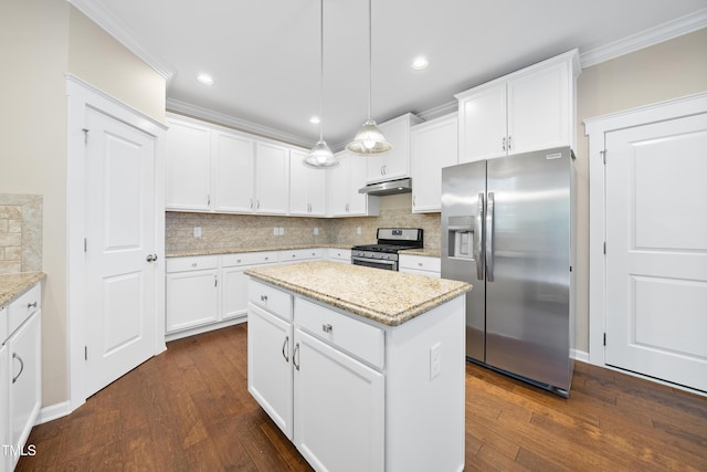 kitchen featuring dark wood finished floors, ornamental molding, backsplash, and appliances with stainless steel finishes