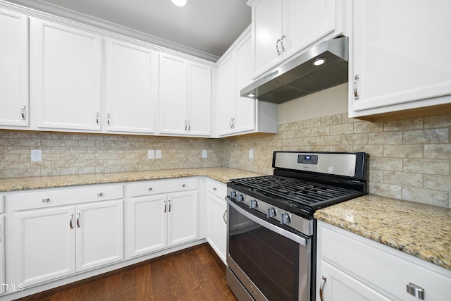 kitchen with under cabinet range hood, stainless steel gas stove, and white cabinetry