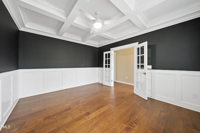 spare room featuring coffered ceiling, french doors, a ceiling fan, and a decorative wall