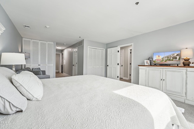 790 New River Inlet Rd Unit 113B, North Topsail Beach, NC 28460 - carpeted bedroom featuring two closets and visible vents