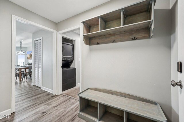 790 New River Inlet Rd Unit 113B, North Topsail Beach, NC 28460 - mudroom featuring stacked washer and clothes dryer, wood finished floors, and baseboards