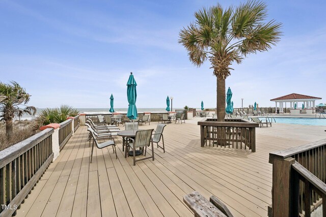 790 New River Inlet Rd Unit 113B, North Topsail Beach, NC 28460 - wooden terrace with a community pool, a gazebo, and outdoor dining space