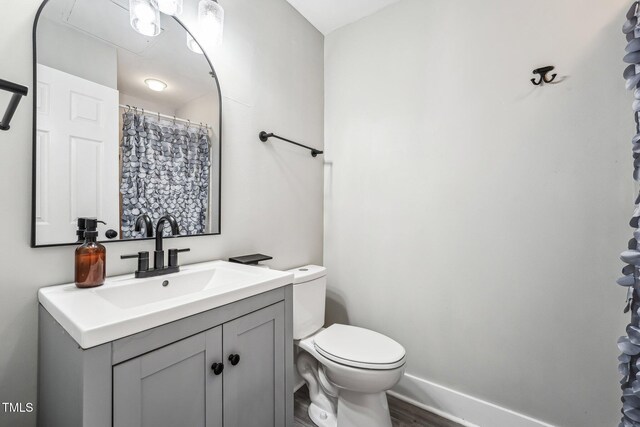 790 New River Inlet Rd Unit 113B, North Topsail Beach, NC 28460 - bathroom featuring wood finished floors, vanity, and toilet