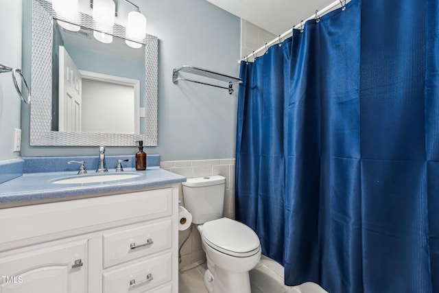 790 New River Inlet Rd Unit 113B, North Topsail Beach, NC 28460 - bathroom featuring wainscoting, vanity, tile walls, toilet, and a shower with shower curtain
