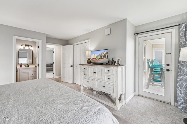 790 New River Inlet Rd Unit 113B, North Topsail Beach, NC 28460 - bedroom featuring a sink, ensuite bathroom, light carpet, baseboards, and access to exterior