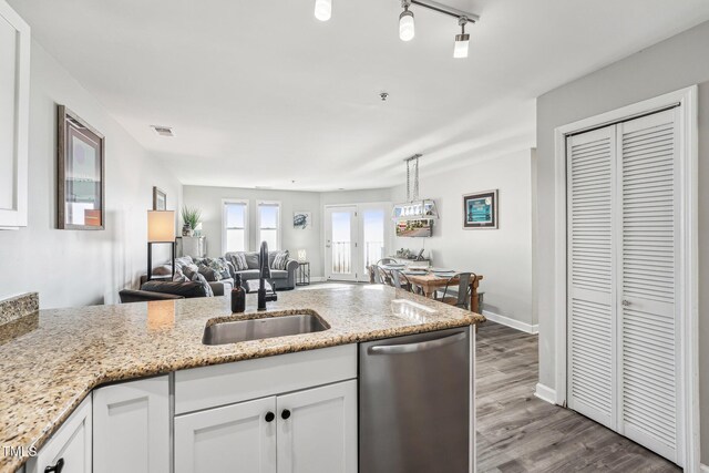 790 New River Inlet Rd Unit 113B, North Topsail Beach, NC 28460 - kitchen featuring white cabinets, visible vents, stainless steel dishwasher, a sink, and open floor plan
