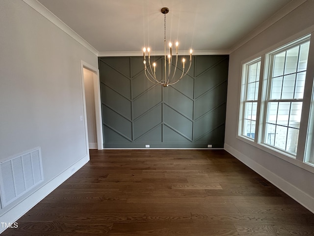unfurnished dining area with crown molding, a chandelier, baseboards, and dark wood-style flooring