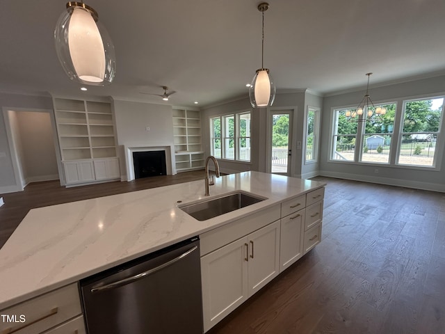kitchen featuring a sink, dishwasher, open floor plan, a fireplace, and dark wood finished floors
