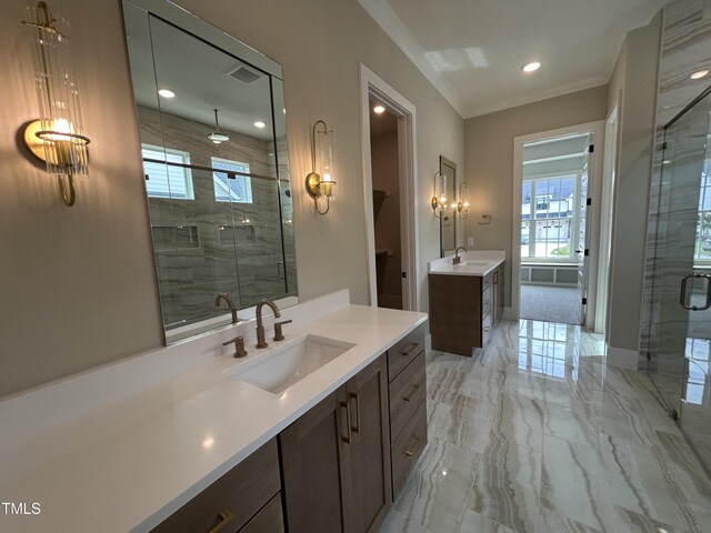 full bath featuring marble tiled floors, a stall shower, two vanities, ornamental molding, and recessed lighting