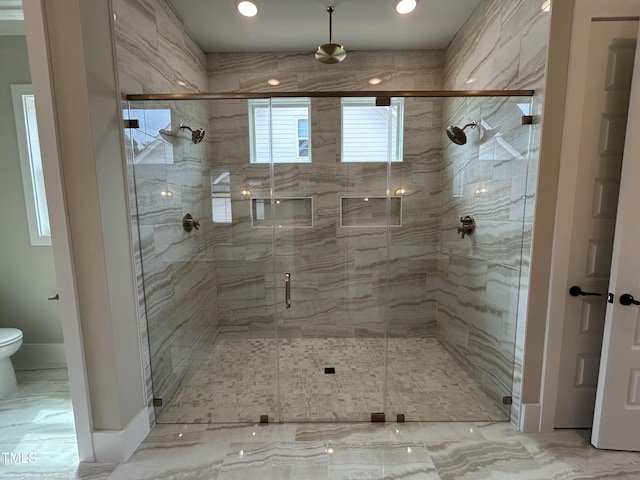 full bath with toilet, a shower stall, marble finish floors, and recessed lighting