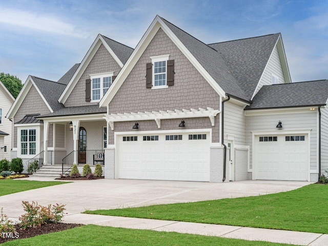 921 Lily Claire Ln, Fuquay Varina, NC 27526 - craftsman-style home featuring driveway, a shingled roof, an attached garage, and a porch