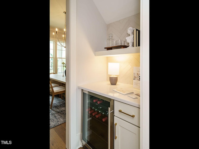 921 Lily Claire Ln, Fuquay Varina, NC 27526 - indoor dry bar with beverage cooler, lofted ceiling, wood finished floors, and a chandelier
