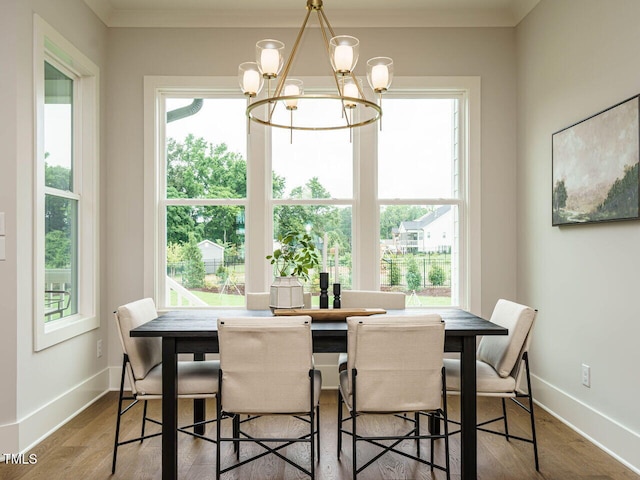 921 Lily Claire Ln, Fuquay Varina, NC 27526 - dining room featuring a chandelier, wood finished floors, and crown molding