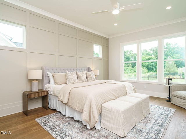 921 Lily Claire Ln, Fuquay Varina, NC 27526 - bedroom with a decorative wall, crown molding, light wood-style floors, recessed lighting, and a ceiling fan