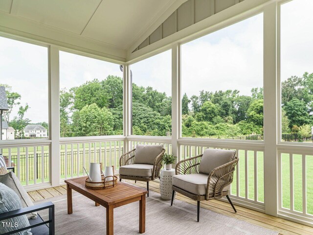 921 Lily Claire Ln, Fuquay Varina, NC 27526 - sunroom / solarium featuring vaulted ceiling, a deck, wood finished floors, and plenty of natural light