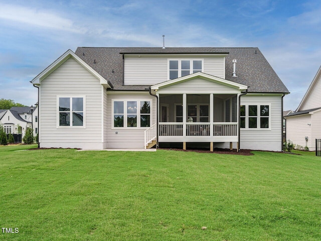 921 Lily Claire Ln, Fuquay Varina, NC 27526 - rear view of house with a sunroom, a yard, and roof with shingles