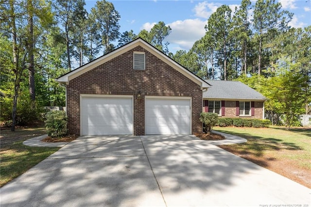 7783 Trappers Rd, Fayetteville, NC 28311 - view of front of home featuring driveway, a garage, a front yard, and brick siding