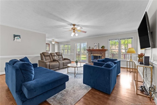 7783 Trappers Rd, Fayetteville, NC 28311 - living room with wood finished floors, a fireplace, crown molding, and ceiling fan