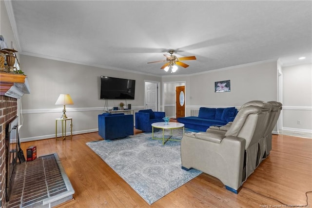 7783 Trappers Rd, Fayetteville, NC 28311 - living room featuring crown molding, wood finished floors, ceiling fan, and a fireplace