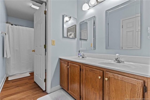 7783 Trappers Rd, Fayetteville, NC 28311 - full bath featuring a sink, baseboards, double vanity, and wood finished floors