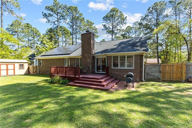 7783 Trappers Rd, Fayetteville, NC 28311 - back of house with a wooden deck, a fenced backyard, an outdoor structure, and a gate