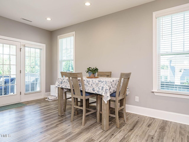 dining space featuring light wood-type flooring, baseboards, plenty of natural light, and recessed lighting