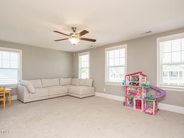 rec room with carpet floors, baseboards, and a ceiling fan