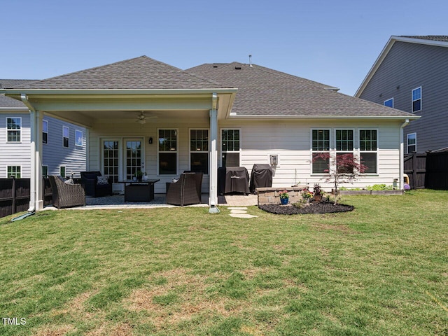 rear view of house with outdoor lounge area, a ceiling fan, a patio area, and roof with shingles