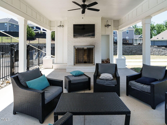 view of patio / terrace featuring fence, an outdoor living space with a fireplace, and a ceiling fan