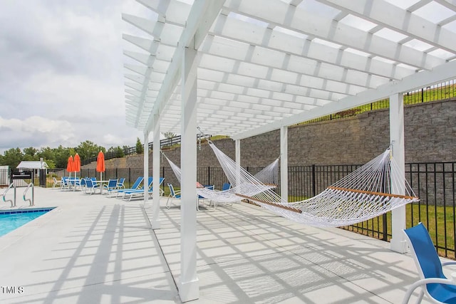 community pool featuring a pergola, fence, and a patio
