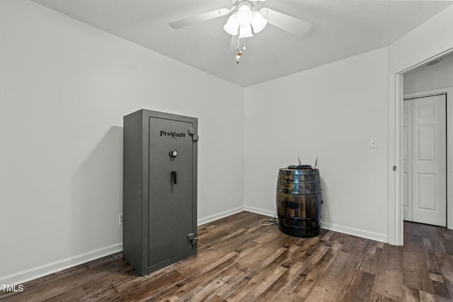 empty room featuring wood finished floors, ceiling fan, and baseboards
